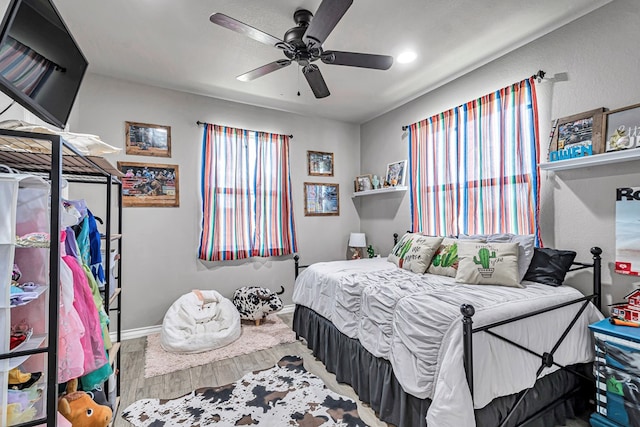 6811 W County Rd 41, Midland, TX 79707 - bedroom with wood finished floors, baseboards, recessed lighting, and ceiling fan