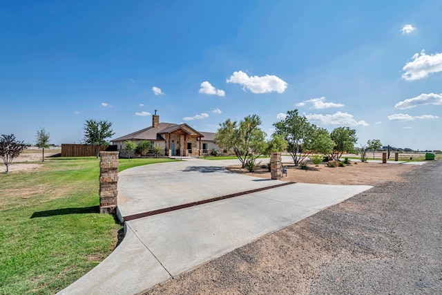 6811 W County Rd 41, Midland, TX 79707 - view of front of home with a front yard, a chimney, and curved driveway
