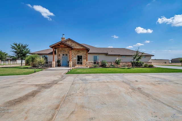 6811 W County Rd 41, Midland, TX 79707 - view of front of home with stone siding, stucco siding, and a chimney