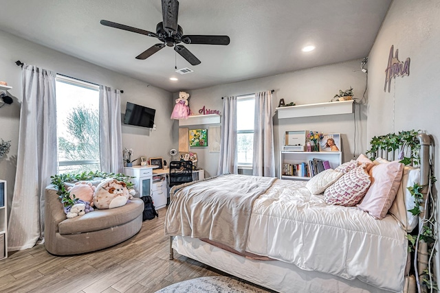6811 W County Rd 41, Midland, TX 79707 - bedroom with multiple windows, light wood-style floors, recessed lighting, and ceiling fan