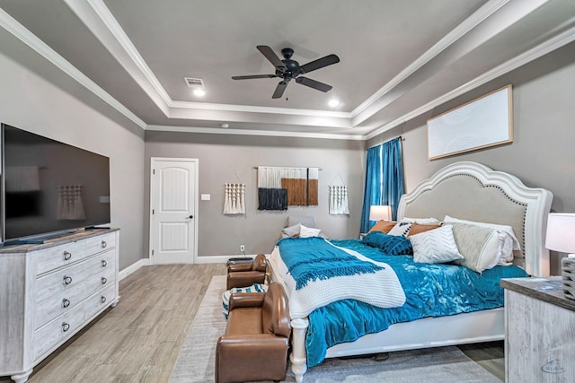 6811 W County Rd 41, Midland, TX 79707 - bedroom featuring a tray ceiling, light wood-style floors, ornamental molding, a ceiling fan, and baseboards