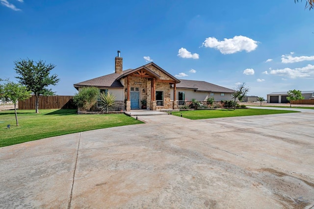 6811 W County Rd 41, Midland, TX 79707 - view of front of property featuring stone siding, a chimney, stucco siding, and concrete driveway