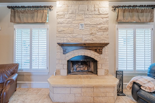 interior details featuring a fireplace, crown molding, and baseboards