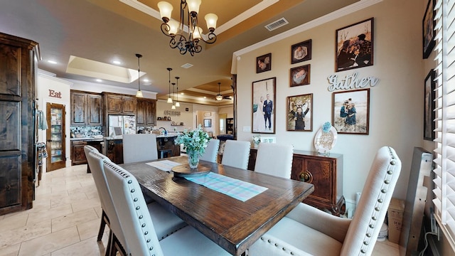 dining space featuring visible vents, a tray ceiling, crown molding, and recessed lighting