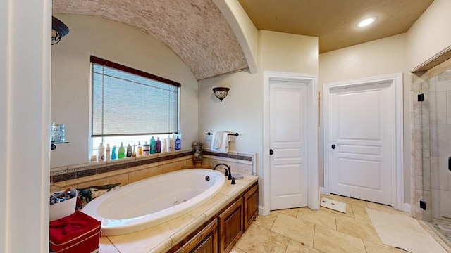 full bathroom featuring vaulted ceiling, a stall shower, a garden tub, and recessed lighting