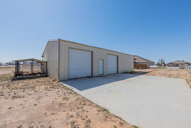 detached garage featuring fence