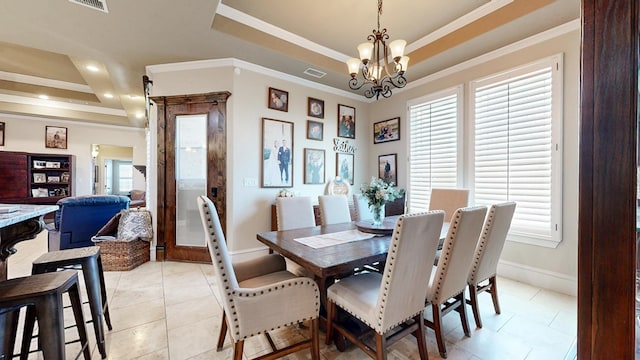 dining space featuring a notable chandelier, visible vents, a tray ceiling, and crown molding