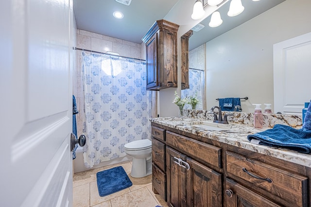 bathroom with tile patterned flooring, vanity, and toilet