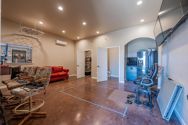 living area with baseboards, arched walkways, and recessed lighting