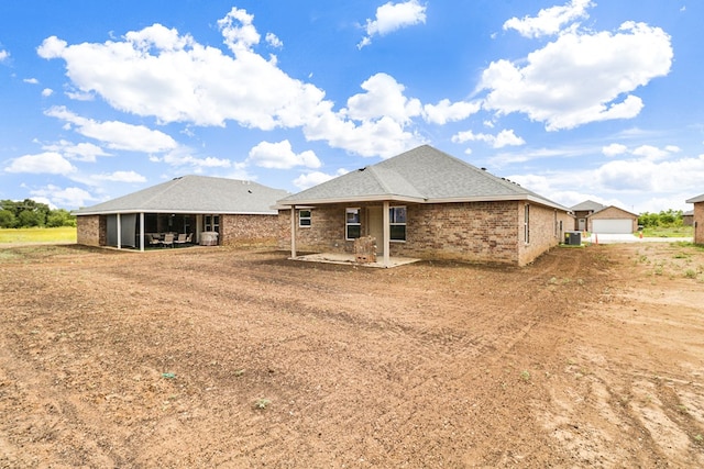 804 Bella Bvd, Coleman, TX 76834 - rear view of house with a patio, a detached garage, and brick siding