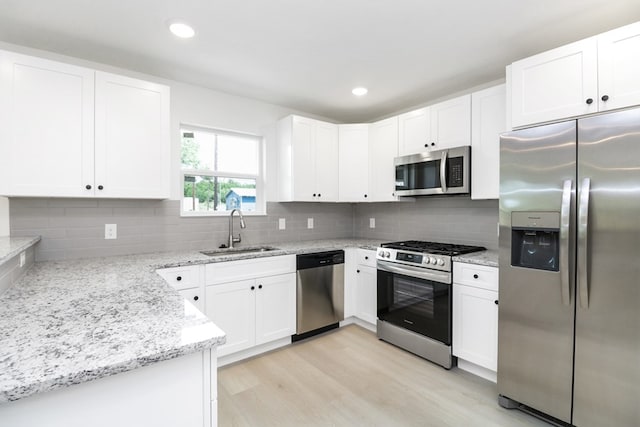 804 Bella Bvd, Coleman, TX 76834 - kitchen featuring appliances with stainless steel finishes, light stone countertops, white cabinetry, and recessed lighting