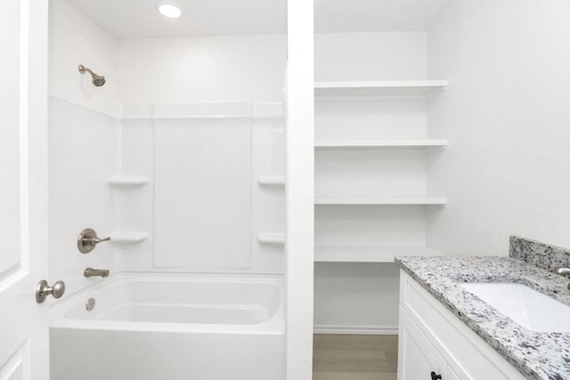 804 Bella Bvd, Coleman, TX 76834 - bathroom featuring bathing tub / shower combination, vanity, and wood finished floors
