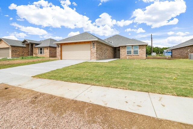 804 Bella Bvd, Coleman, TX 76834 - view of front of home featuring brick siding, an attached garage, concrete driveway, a front lawn, and roof with shingles