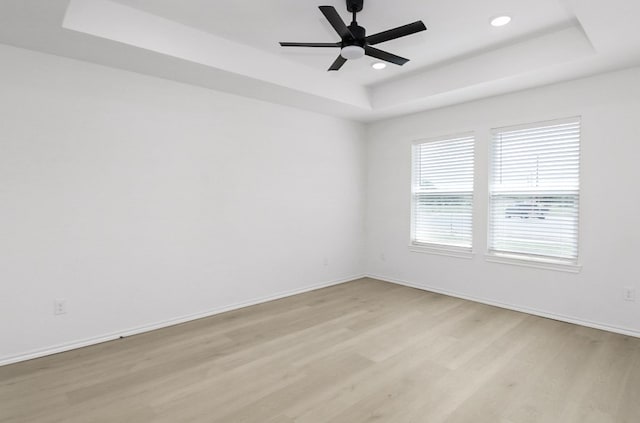 804 Bella Bvd, Coleman, TX 76834 - unfurnished room featuring a tray ceiling, light wood-type flooring, recessed lighting, and a ceiling fan
