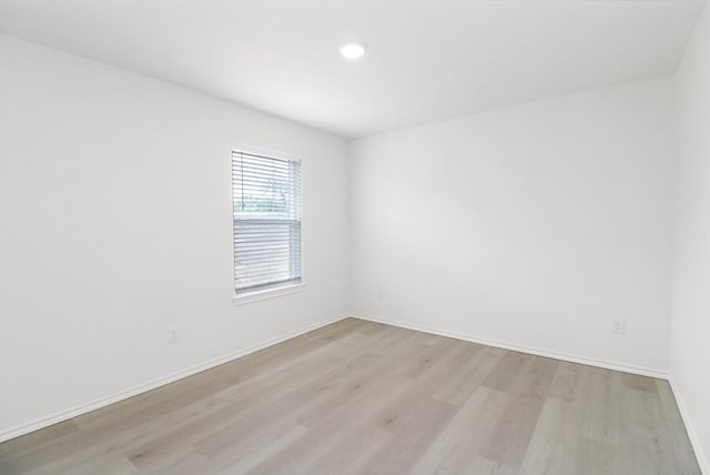 804 Bella Bvd, Coleman, TX 76834 - empty room featuring light wood-style flooring and recessed lighting