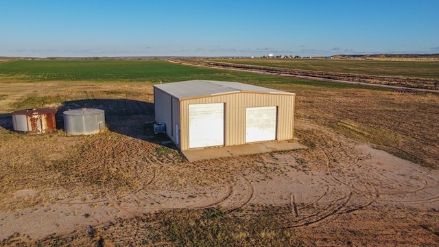 view of outbuilding with cooling unit, a rural view, and an outdoor structure