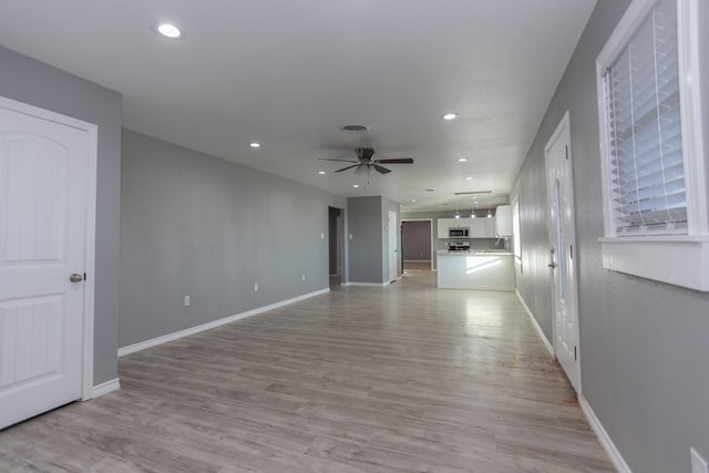 unfurnished living room featuring recessed lighting, baseboards, ceiling fan, and light wood finished floors