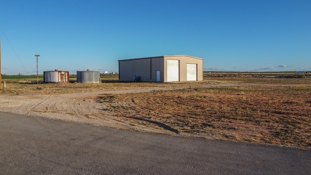 view of outdoor structure featuring an outbuilding and a rural view