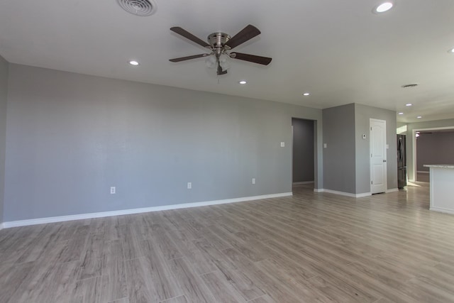 unfurnished living room featuring recessed lighting, visible vents, light wood-style floors, a ceiling fan, and baseboards