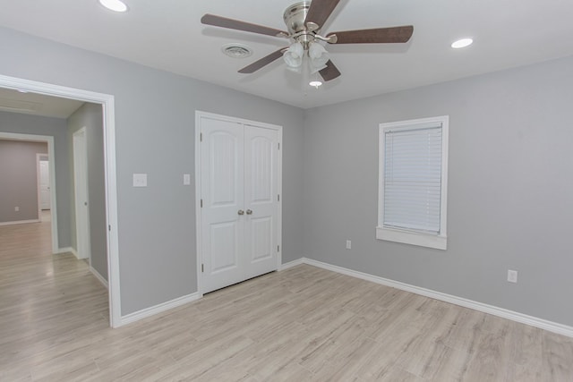 unfurnished bedroom featuring recessed lighting, a ceiling fan, baseboards, light wood-style floors, and a closet