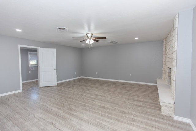 unfurnished living room featuring baseboards, ceiling fan, and light wood finished floors