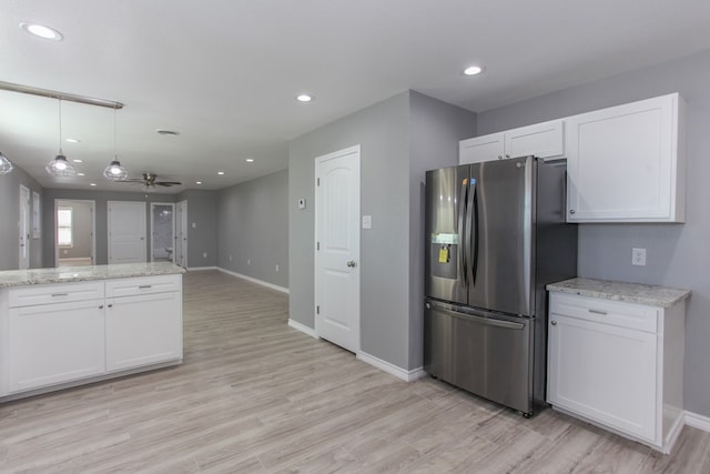 kitchen featuring open floor plan, white cabinets, and stainless steel fridge with ice dispenser