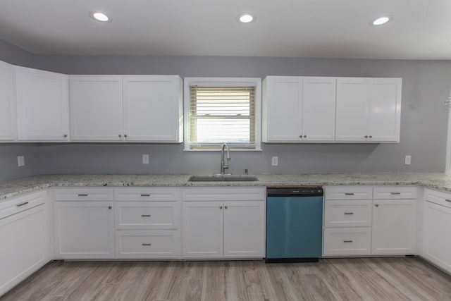 kitchen featuring light stone counters, light wood-style flooring, a sink, white cabinets, and dishwasher