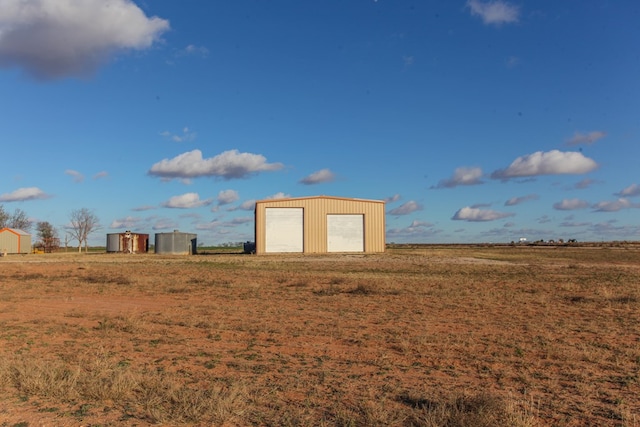 view of outbuilding featuring a rural view and an outdoor structure