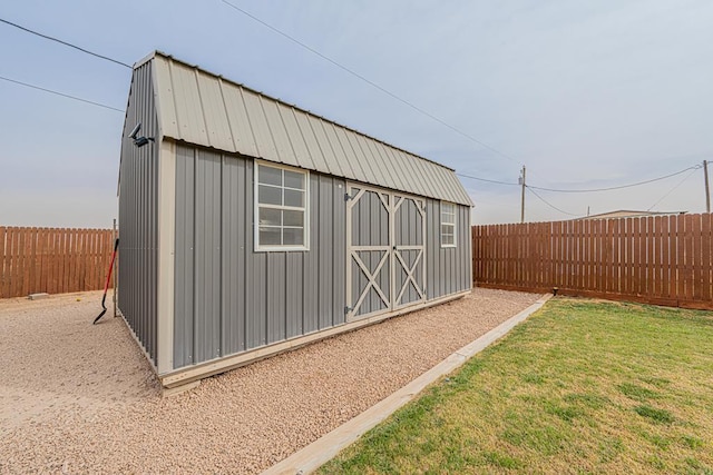 view of outdoor structure featuring an outbuilding and a fenced backyard