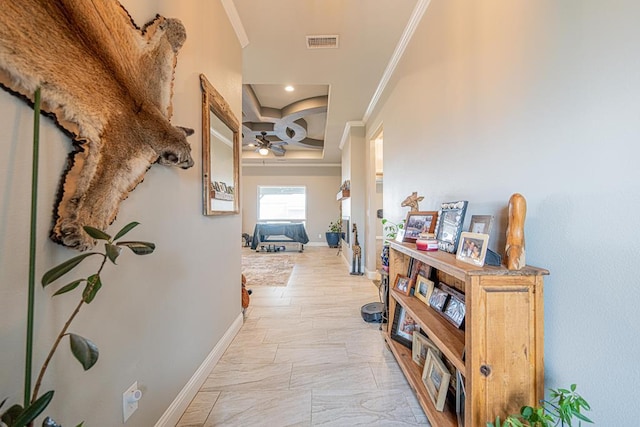 hall with ornamental molding, visible vents, and baseboards