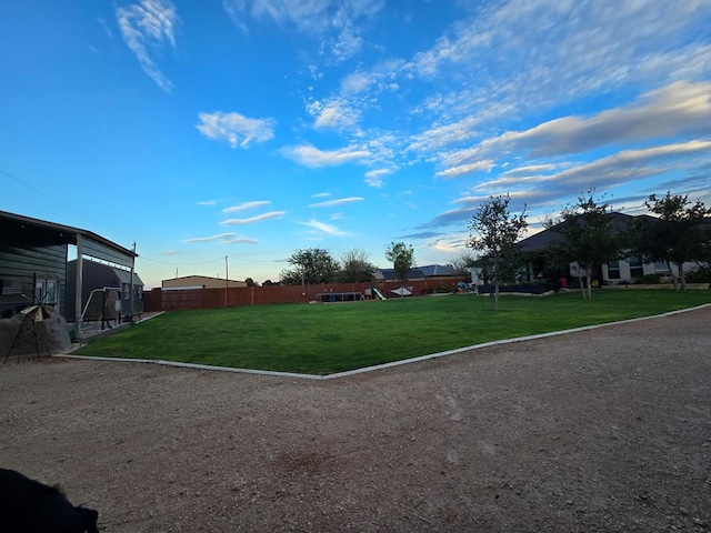 view of yard featuring fence and playground community