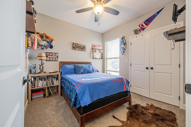 carpeted bedroom featuring a closet and a ceiling fan