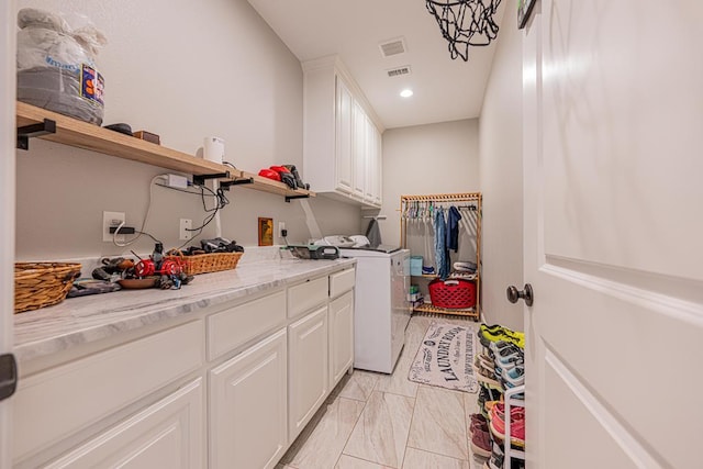 laundry room with cabinet space, recessed lighting, visible vents, and washing machine and clothes dryer