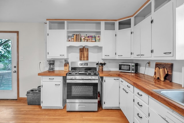 kitchen featuring stainless steel appliances, white cabinets, open shelves, and light wood finished floors