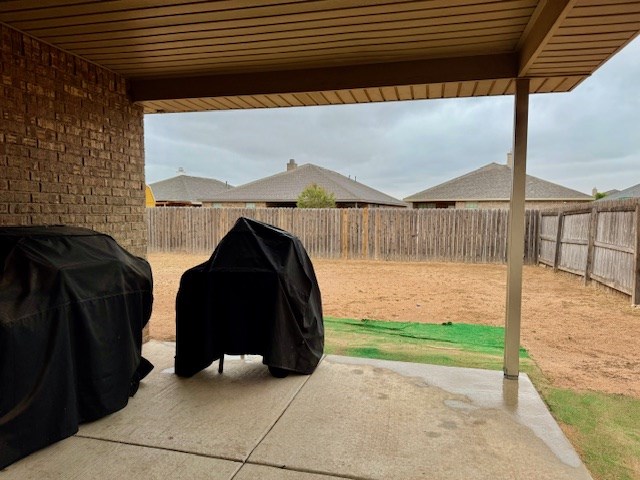 view of patio with a fenced backyard and a grill