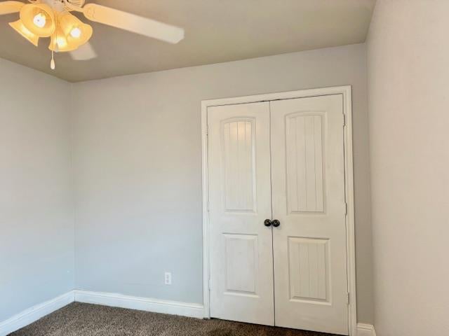 606 Memorial Ct, Midland, TX 79706 - unfurnished bedroom with baseboards, dark carpet, a closet, and a ceiling fan