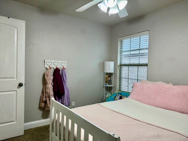 carpeted bedroom with baseboards and ceiling fan