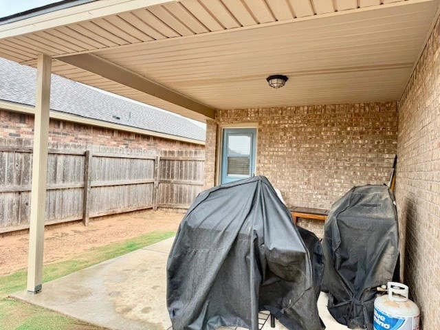 view of patio / terrace featuring area for grilling and fence