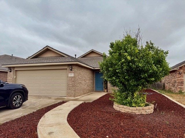 606 Memorial Ct, Midland, TX 79706 - view of front of house with brick siding, driveway, a garage, and roof with shingles