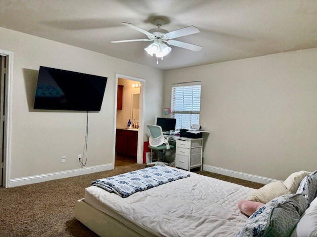 bedroom featuring baseboards, a ceiling fan, carpet floors, and ensuite bath