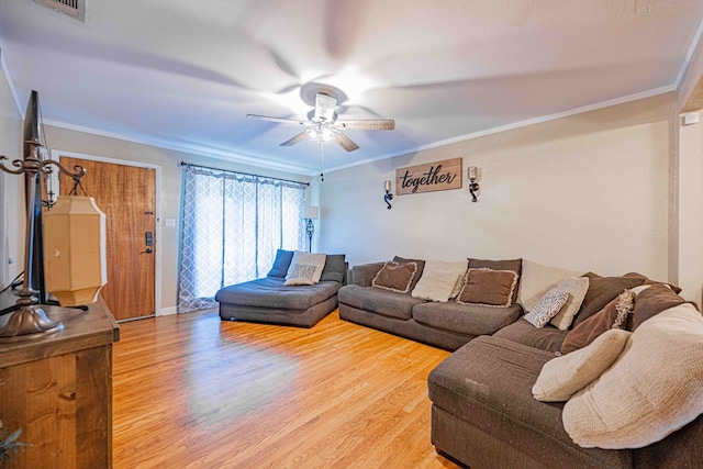 living room featuring hardwood / wood-style floors, ceiling fan, and crown molding