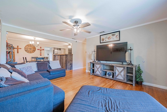 living room featuring wood-type flooring and crown molding