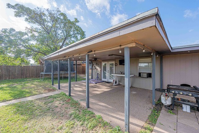 view of patio featuring area for grilling, french doors, and a trampoline