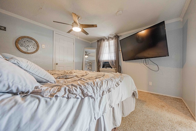 carpeted bedroom with ceiling fan, crown molding, and a textured ceiling