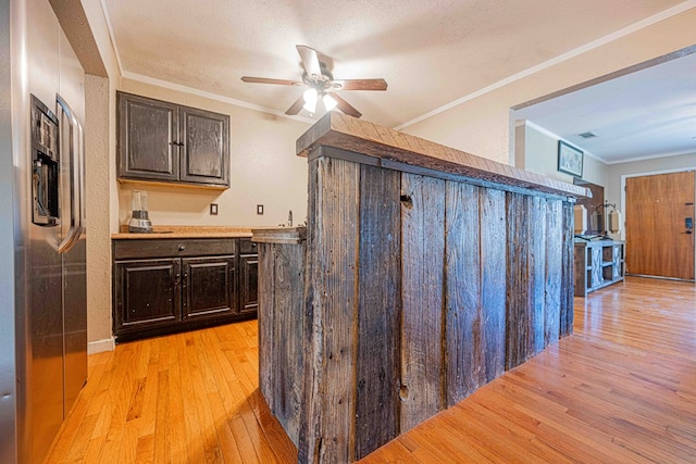 interior space with dark brown cabinetry, ceiling fan, light hardwood / wood-style flooring, and ornamental molding