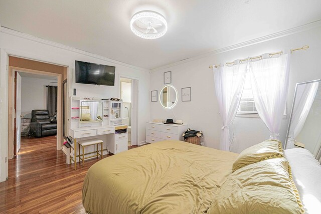 bedroom with hardwood / wood-style flooring and ornamental molding