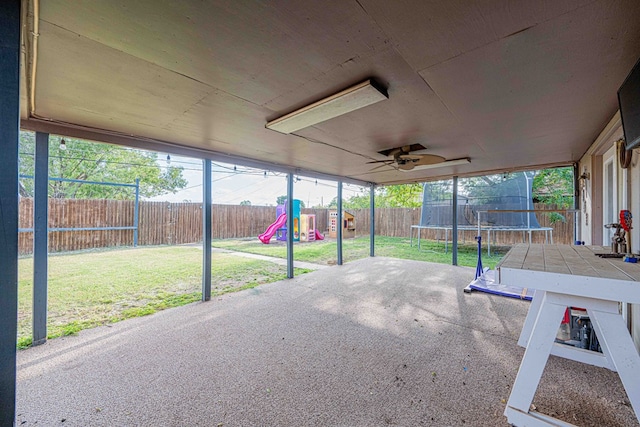 view of patio featuring a playground, a trampoline, and ceiling fan