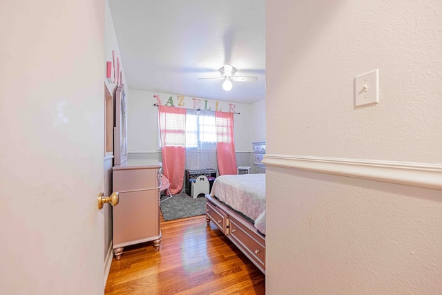 bedroom with light wood-type flooring and ceiling fan