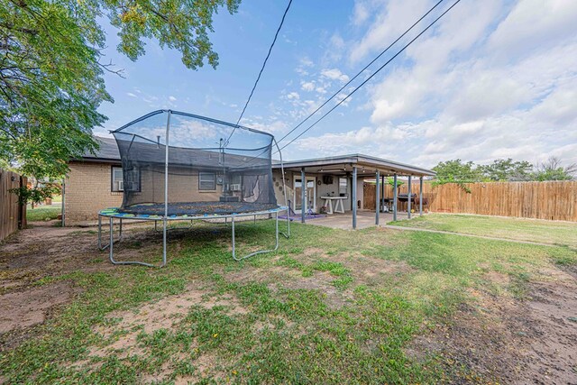 view of yard with a patio area and a trampoline