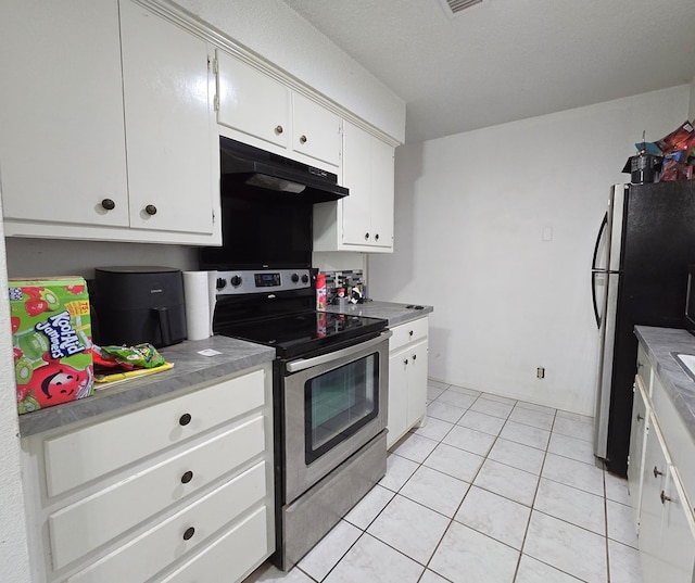 kitchen with appliances with stainless steel finishes, under cabinet range hood, white cabinetry, and light tile patterned floors